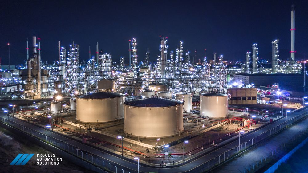 overhead photo oil refinery lit up at nighttime